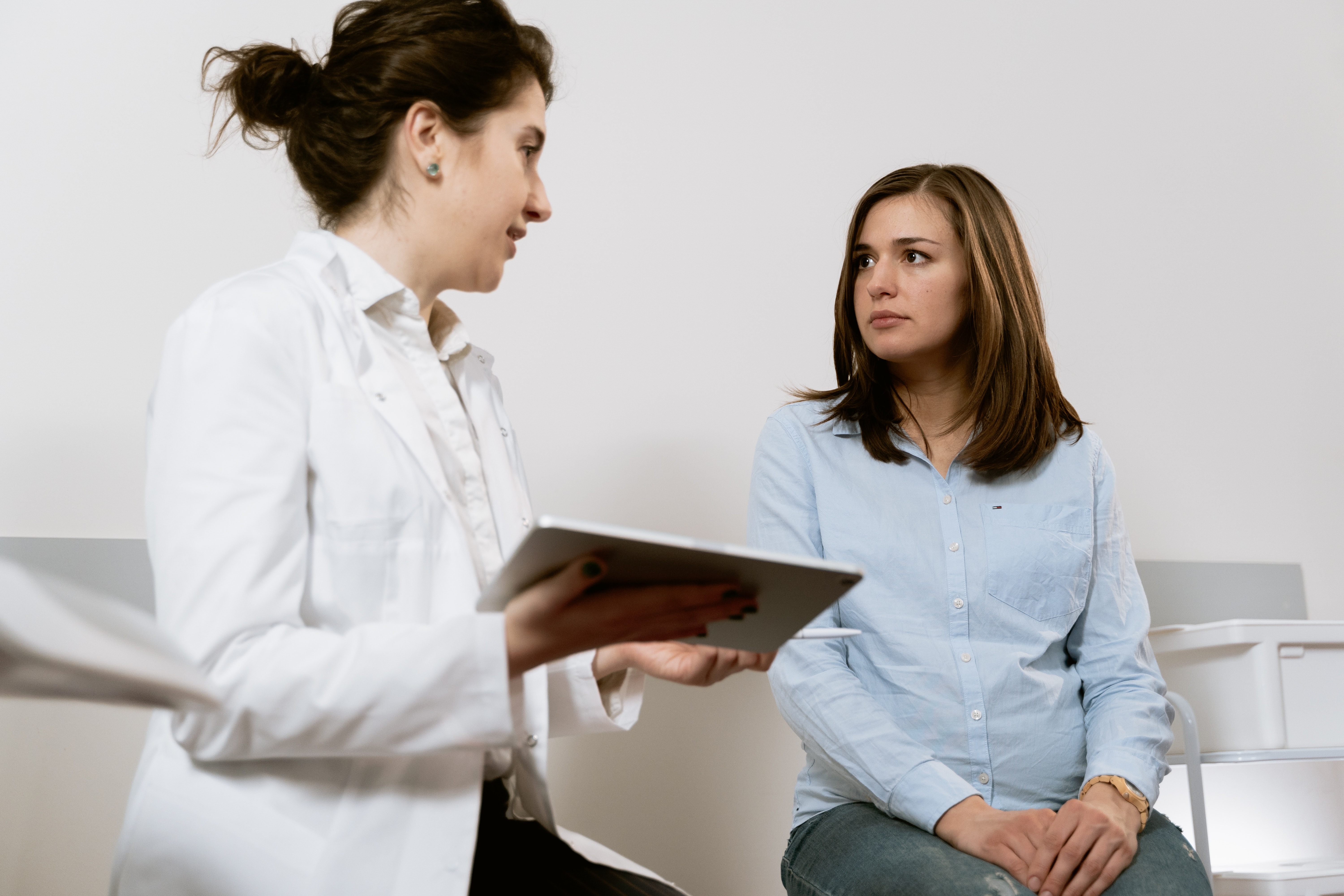 woman sitting with doctor in office