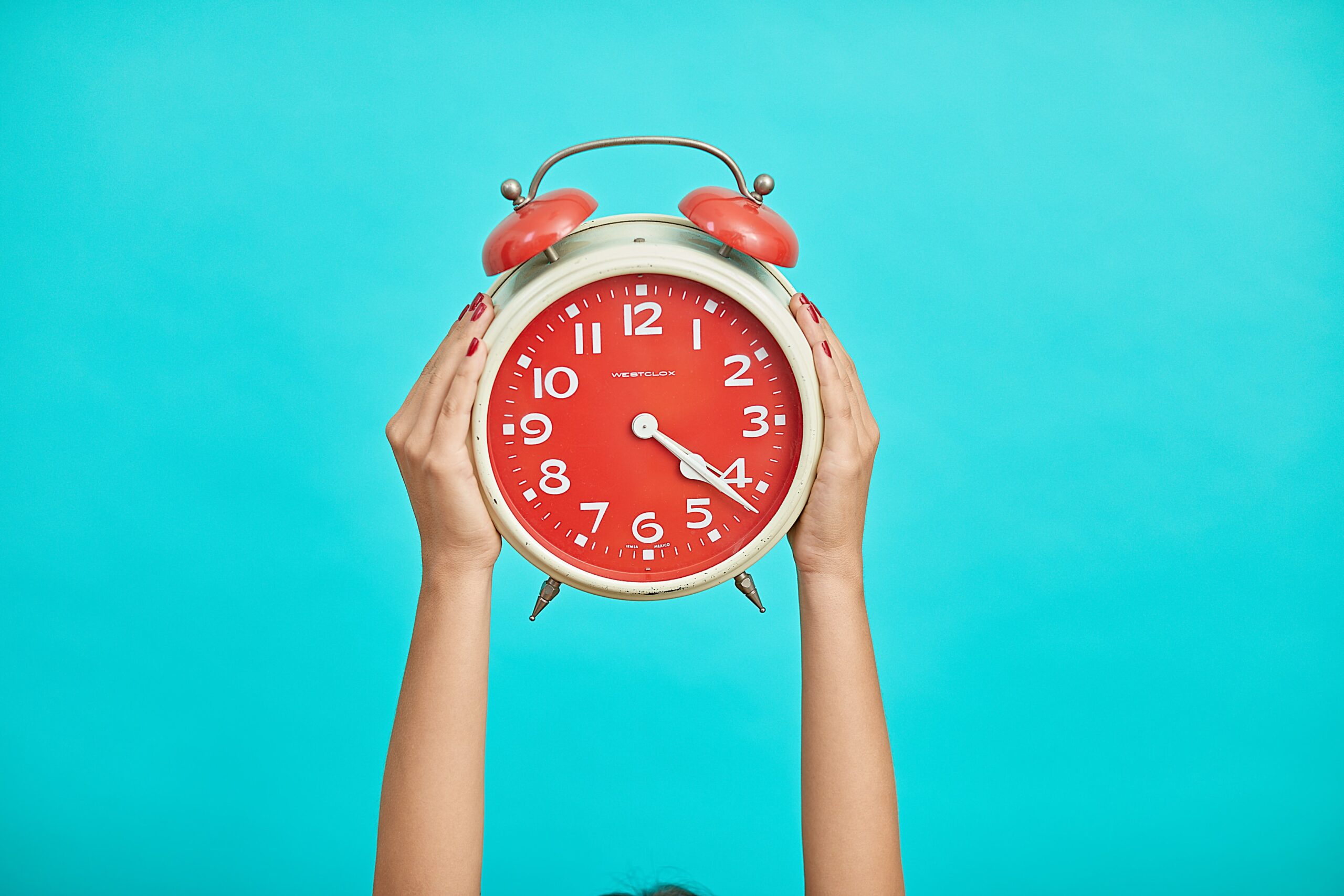 Hands holding a clock